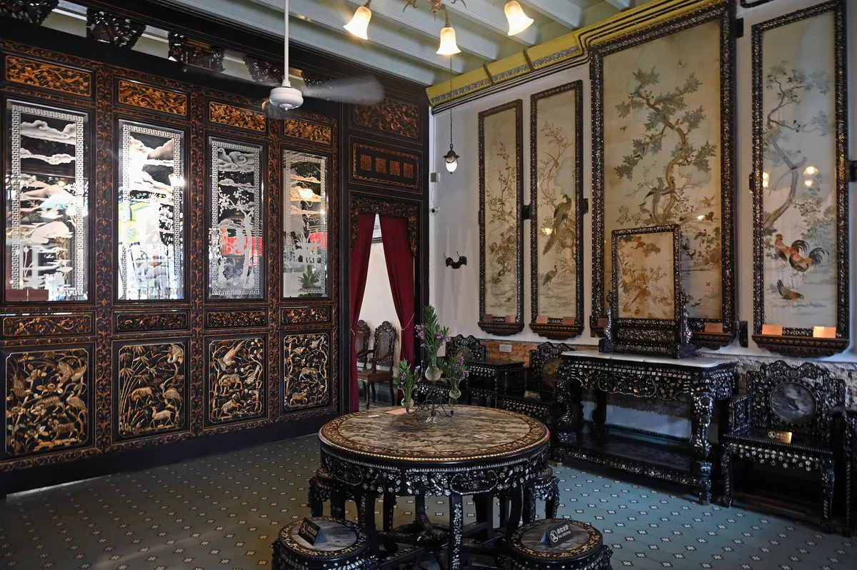The richly carved reception hall inside the Baba Nyonya Heritage Museum in Melaka