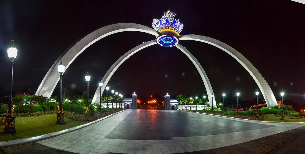 The giant royal crown arch at the entrance of Istana Bukit Serene in Johor Bahru, lit at night