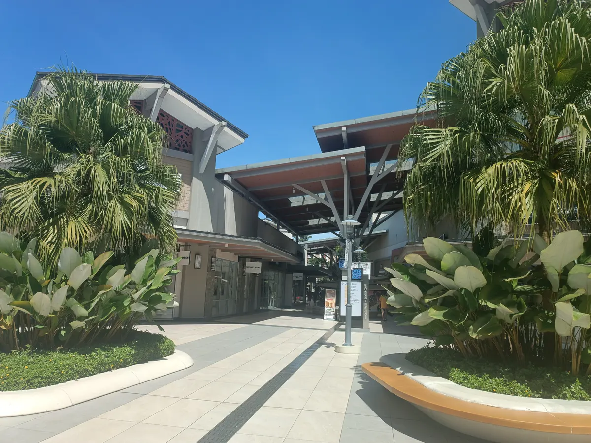 The open-air shopping village at Genting Highlands Premium Outlets with palm trees