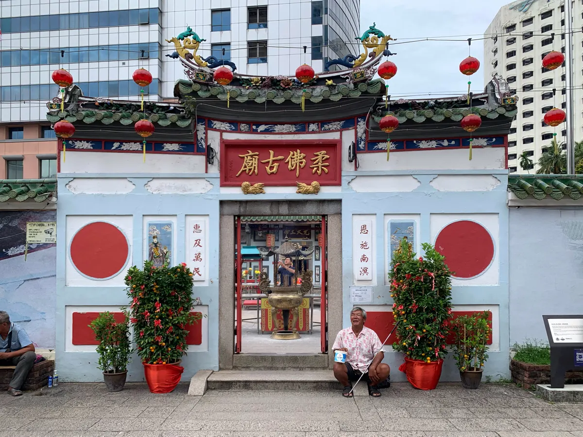 The colourful entrance of the Old Chinese Temple in Johor Bahru with red lanterns