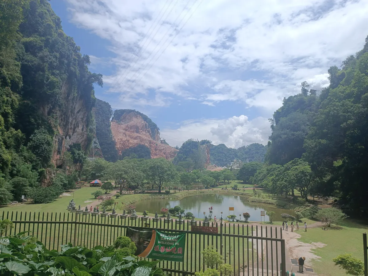 A garden and lake below limestone cliffs at Kek Look Tong in Ipoh