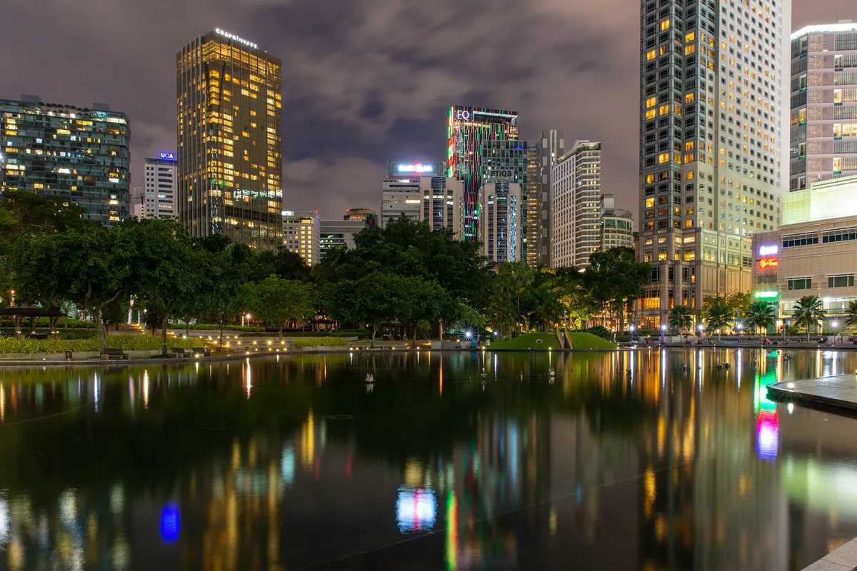The lake at KLCC Park with city towers reflected at night