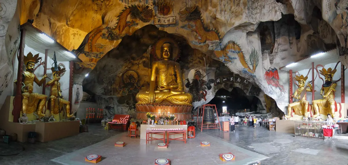A golden Buddha seated inside the Perak Tong cave temple in Ipoh