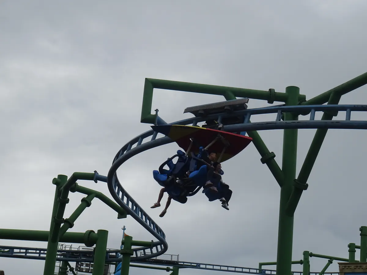 A ride swinging over the track at Genting SkyWorlds theme park