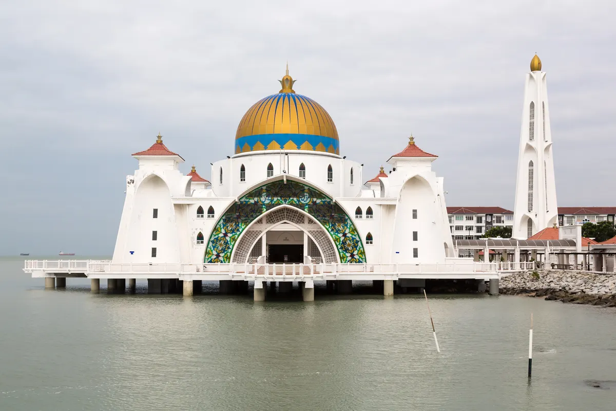 The Melaka Straits Mosque with its golden dome standing on the water